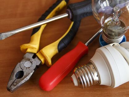 Electrician tools including screw drivers, pliers and light bulbs